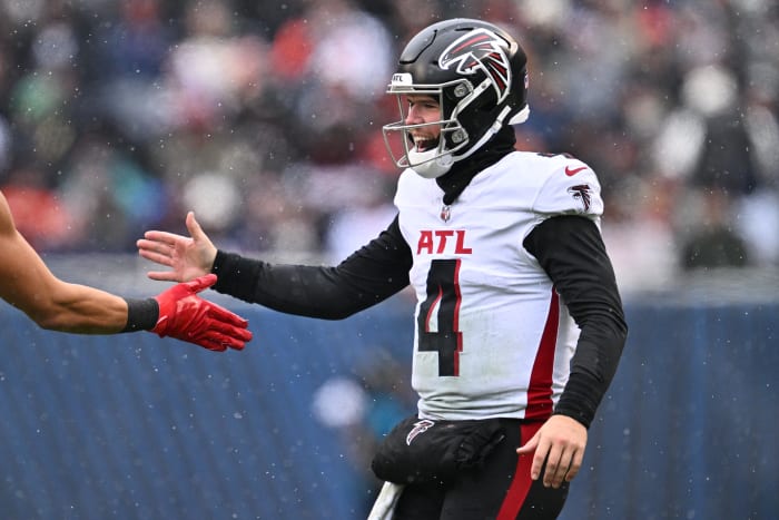 Dec 31, 2023; Chicago, Illinois, USA; Atlanta Falcons quarterback Taylor Heinicke (4) celebrates after throwing a 75-yard touchdown pass in the first half against the Chicago Bears at Soldier Field.